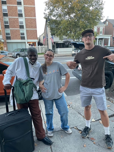 Volunteers with a neighbor on a Pottstown sidewalk